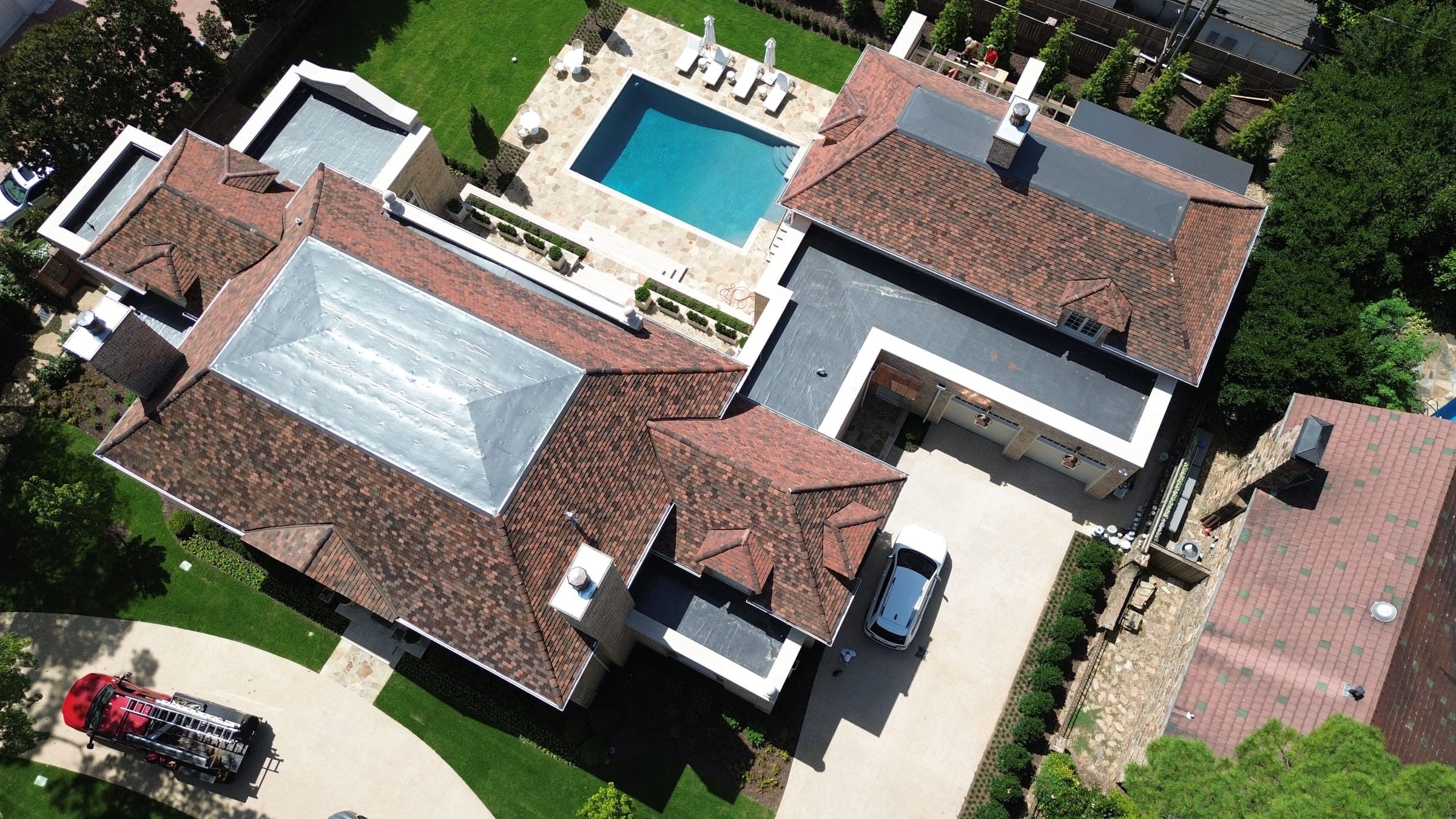 Clay tile roof wrapping a courtyard with a pool
