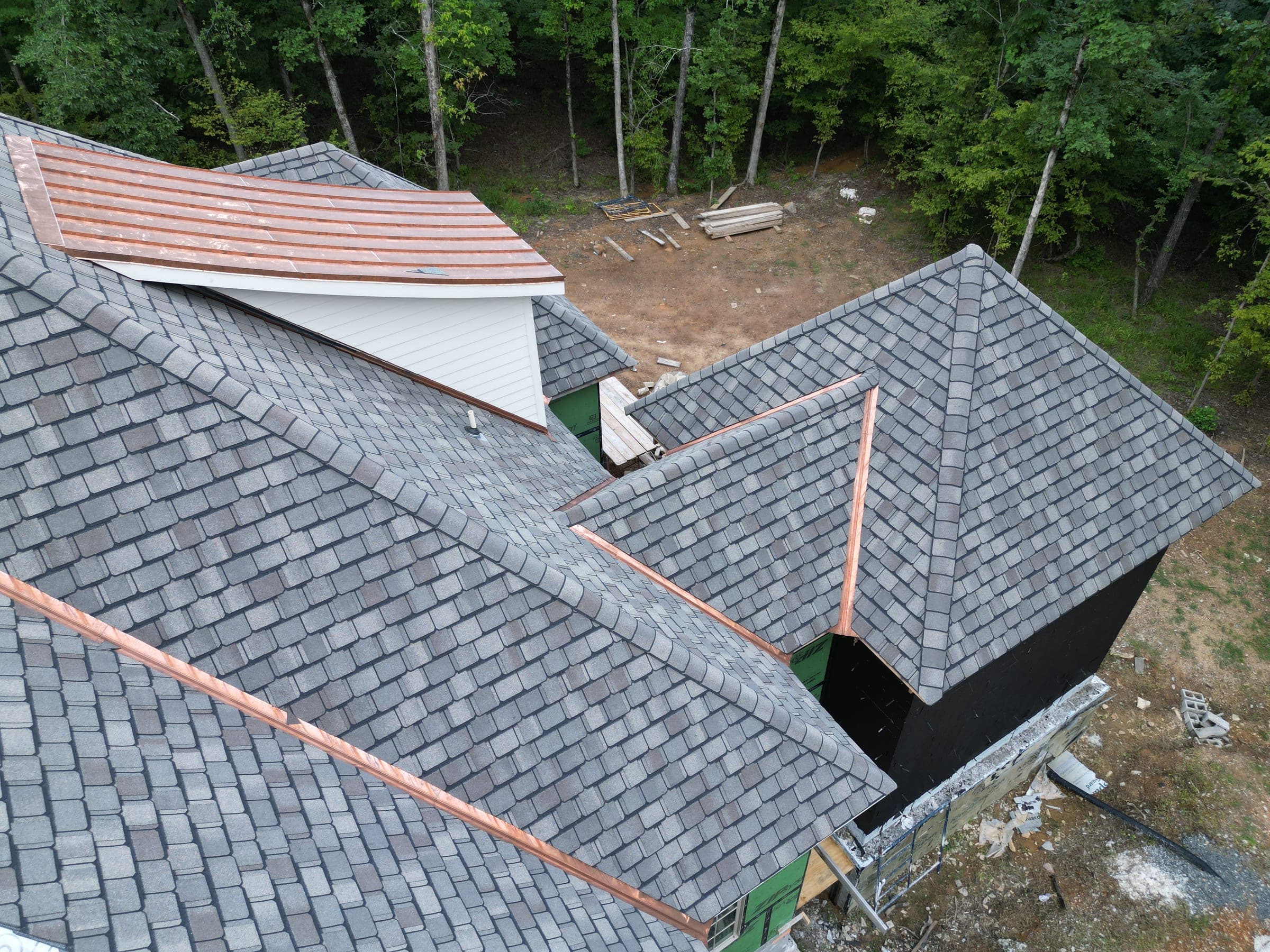 Copper valley flashing running between slate-look roof planes beside a dormer