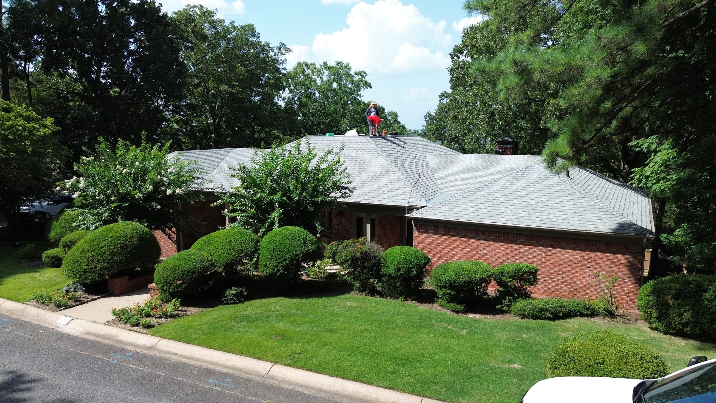 Brick ranch home with a new shingle roof and landscaped front yard