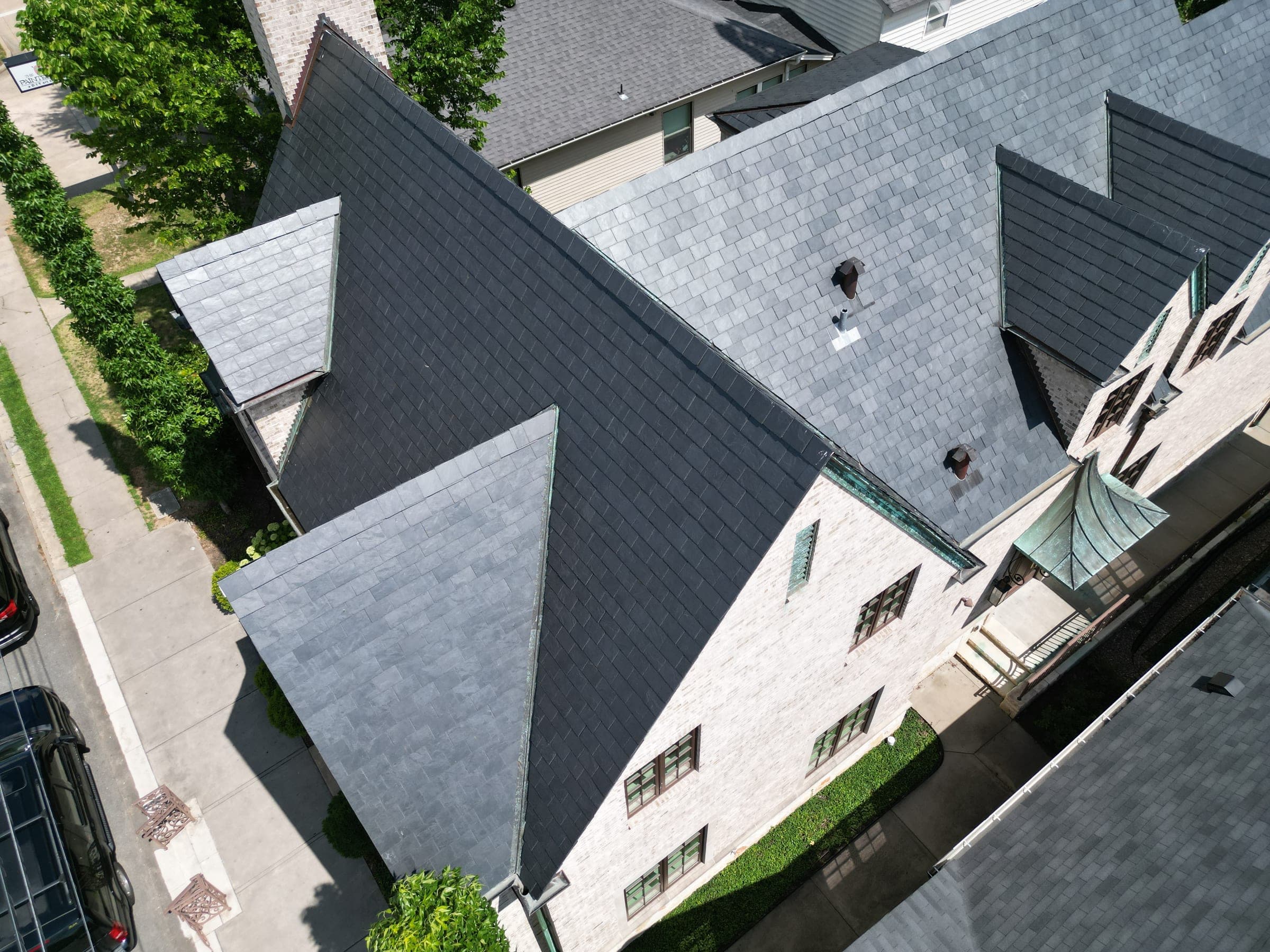 Steep-pitch slate roof with intersecting gables